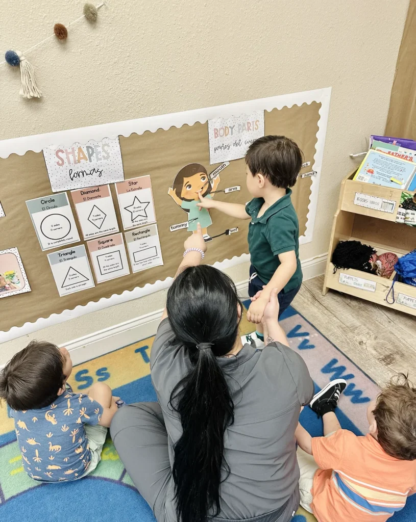 Daycare teacher teaching shapes and body parts Webster TX